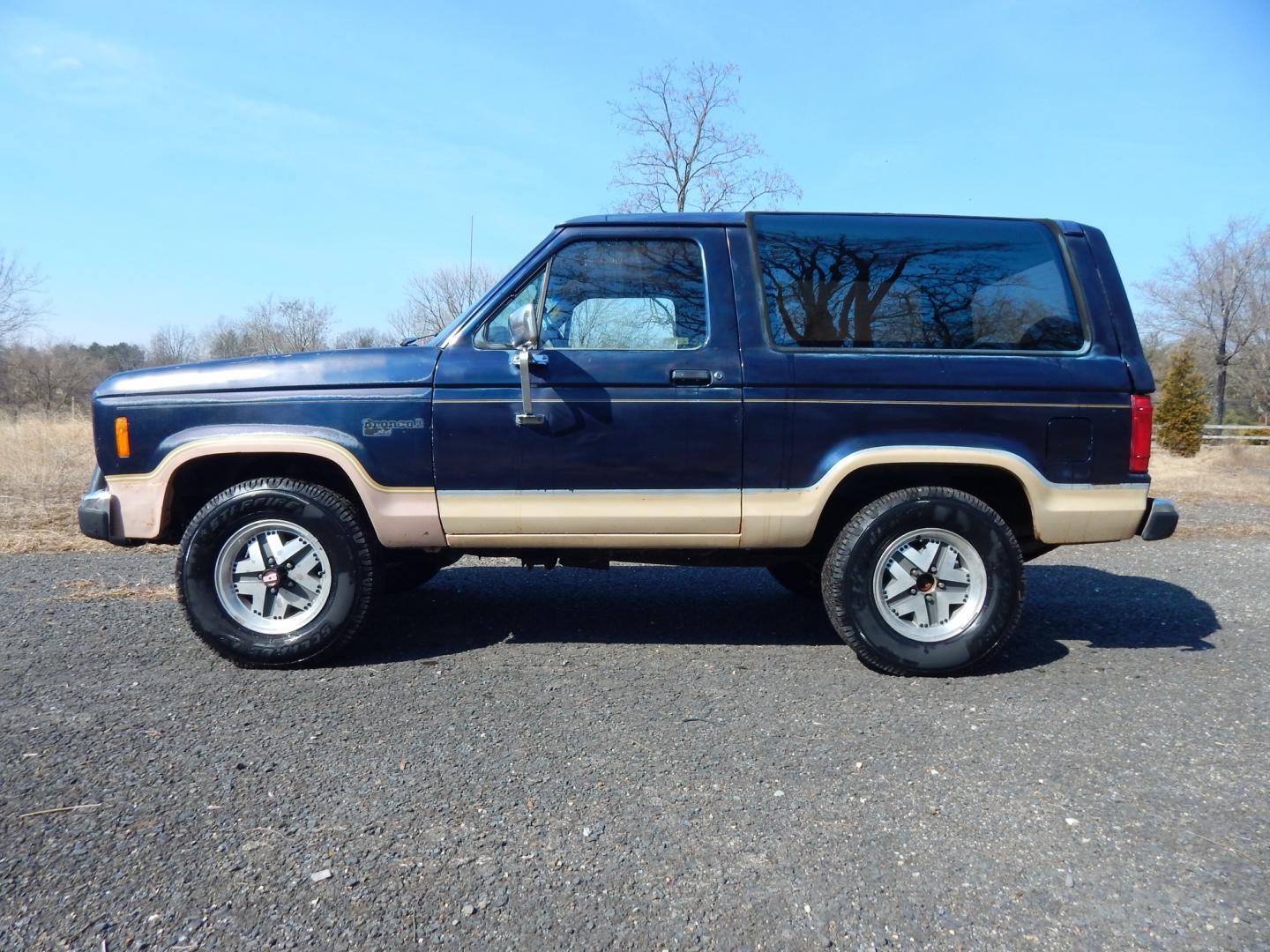 1988 Blue /Tan Ford Bronco II 4WD (1FMCU14T6JU) with an 2.9L V6 OHV 12V engine, 4-Speed Automatic Overdrive transmission, located at 6528 Lower York Road, New Hope, PA, 18938, (215) 862-9555, 40.358707, -74.977882 - Here we have a 1988 Ford Bronco 2 with a 2.9L V6 putting power to a 4x4 automatic transmission. Options include: tan cloth interior, heat/AC, XD Vision radio, power windows, cruise control, tilt steering wheel, front/rear defrost windows, spare tire cover, 15 inch alloy wheels with 4 Solarus AP tire - Photo#14